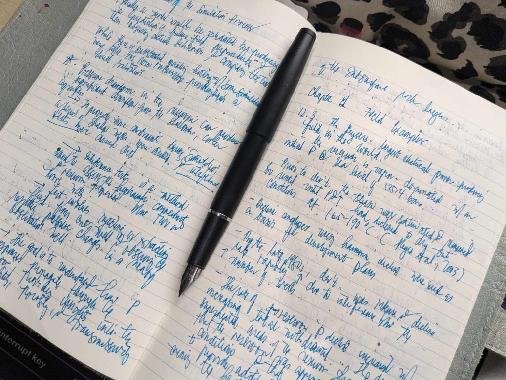 Black Jinhao 80 with my reservoir modeling notes on Moleskine notebook